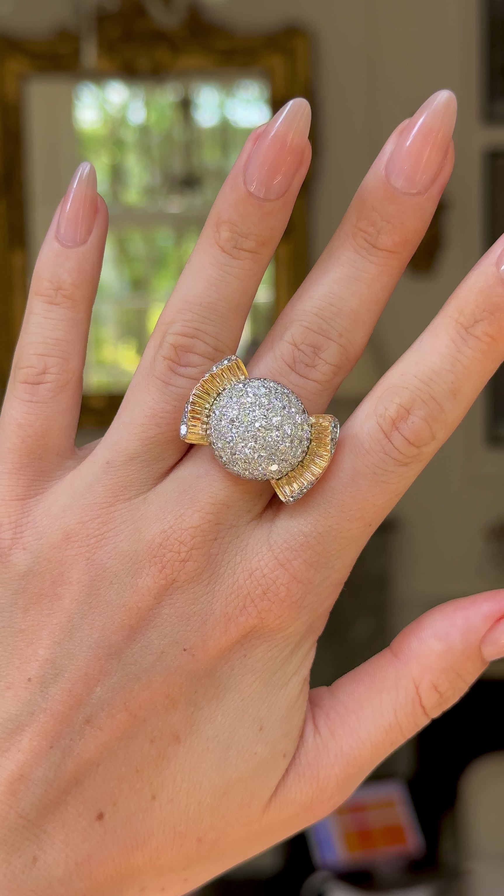 Cartier diamond bombe ring worn on hand and moved around to give perspective.