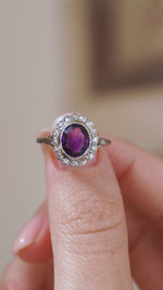Video detail of the Edwardian amethyst ring balanced on a fingertip, highlighting the scalloped old-cut diamond cluster.