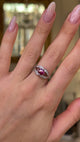 Vintage art deco ruby and diamond ring worn on hand and moved around to give perspective.