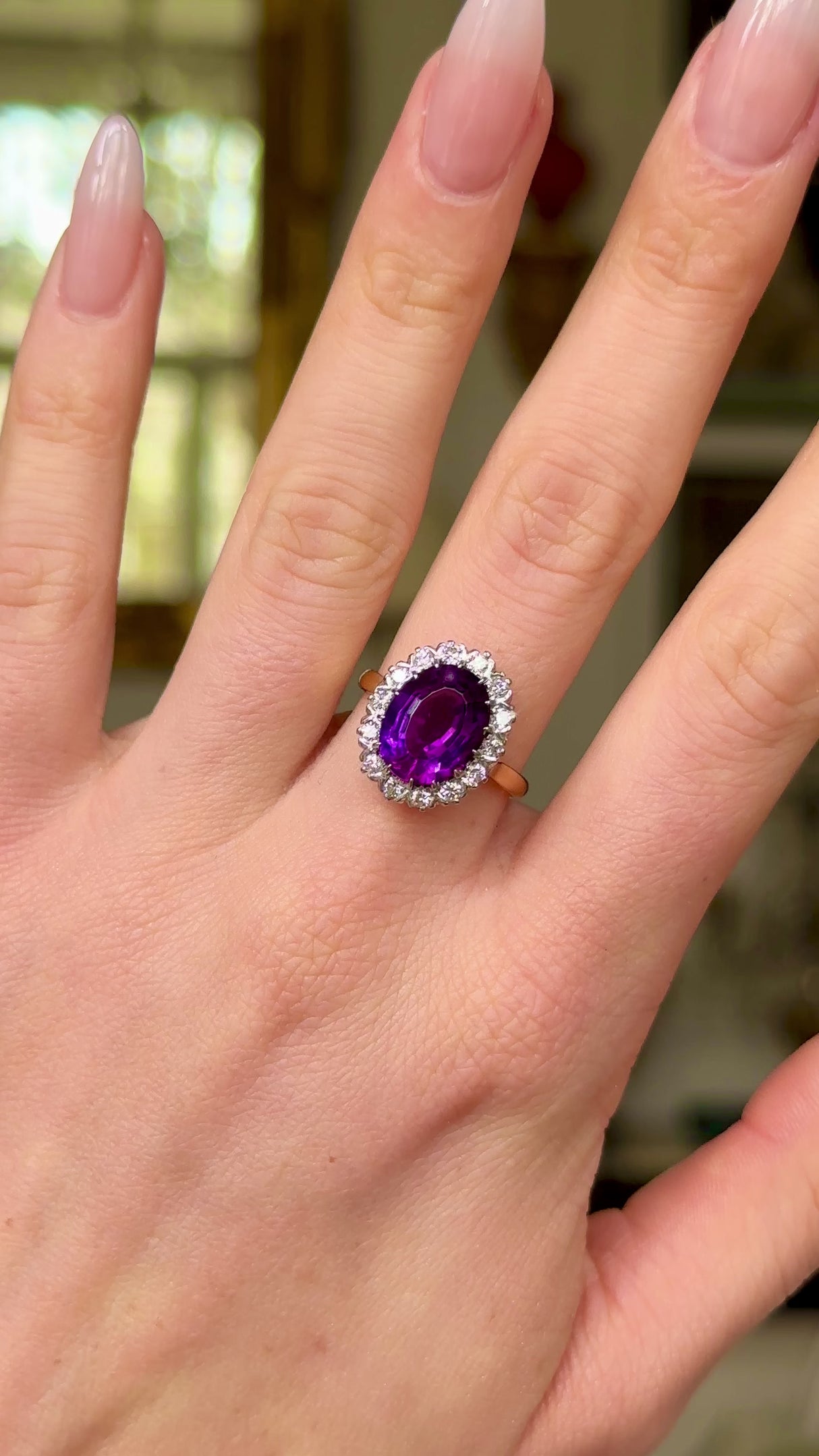 Vintage amethyst and diamond cluster ring, worn on hand and moved around to give perspective.