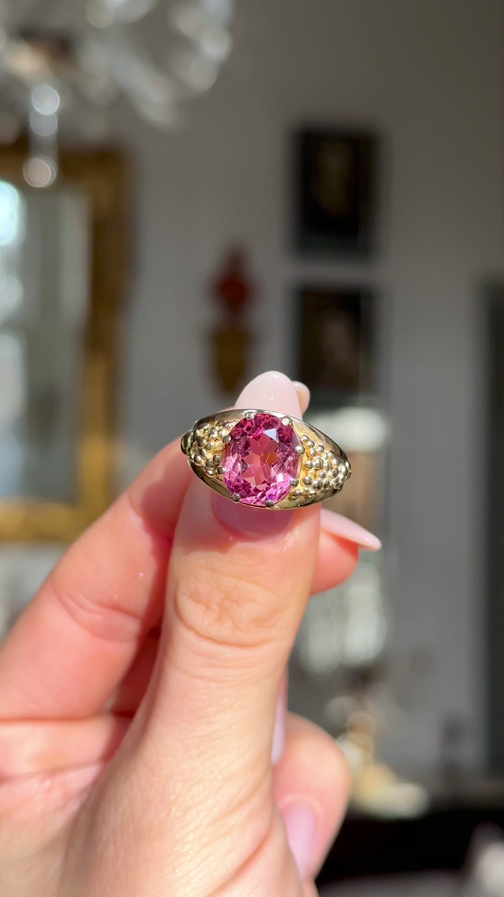 Victorian antique pink tourmaline ring held in fingers and moved around to give perspective.