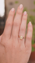 a videos of an Antique-inspired, cushion-cut diamond solitaire engagement ring in yellow gold being worn on the hand