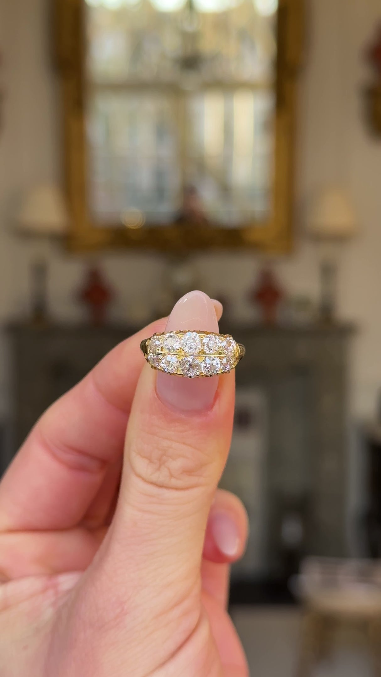 victorian double row diamond band held in fingers and moved around to give perspective.