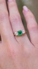 A video of a vintage 1960s emerald and diamond three-stone ring shown on a hand.