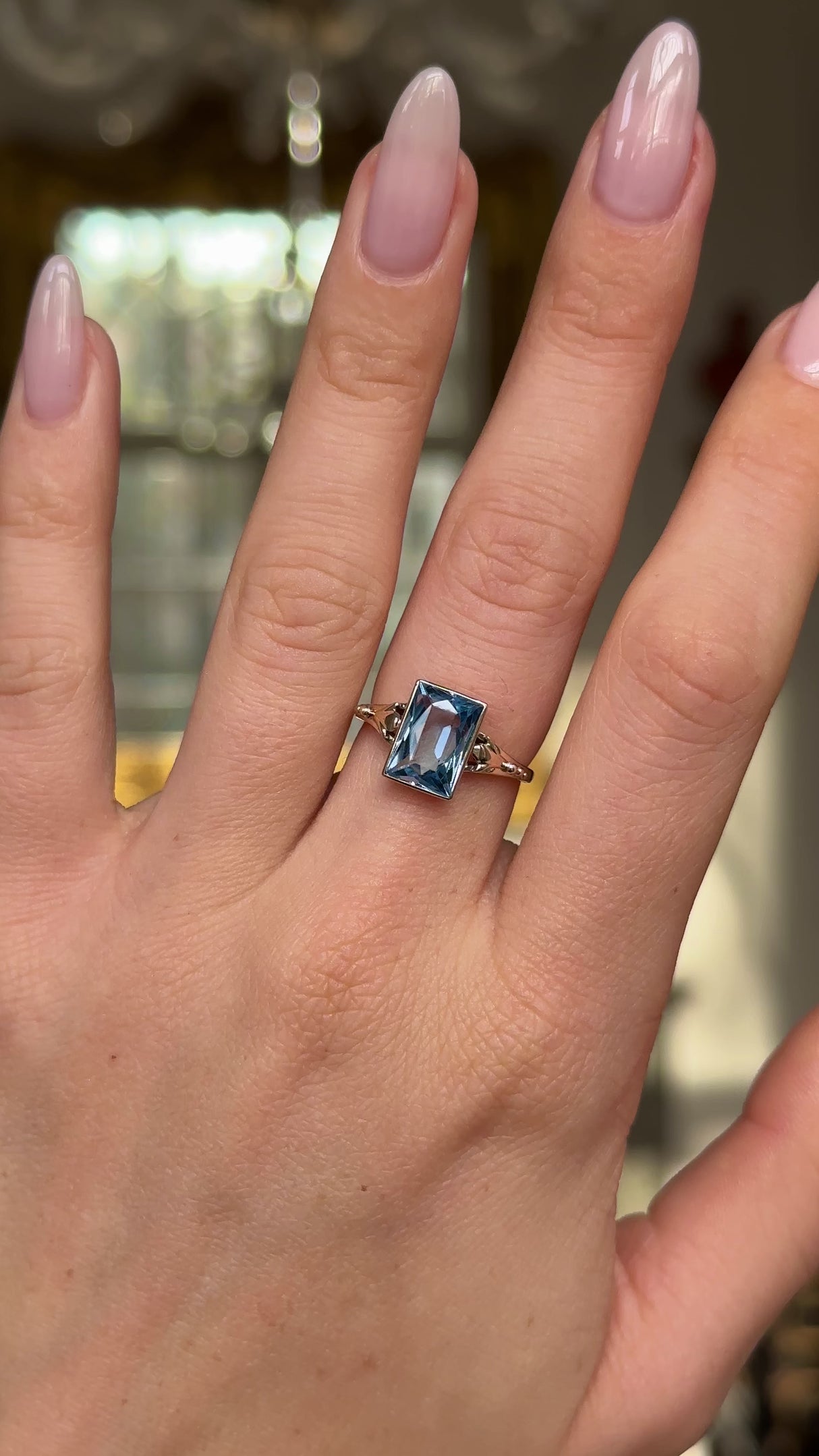 antique aquamarine single stone ring worn on hand and moved around to give perspective. 
