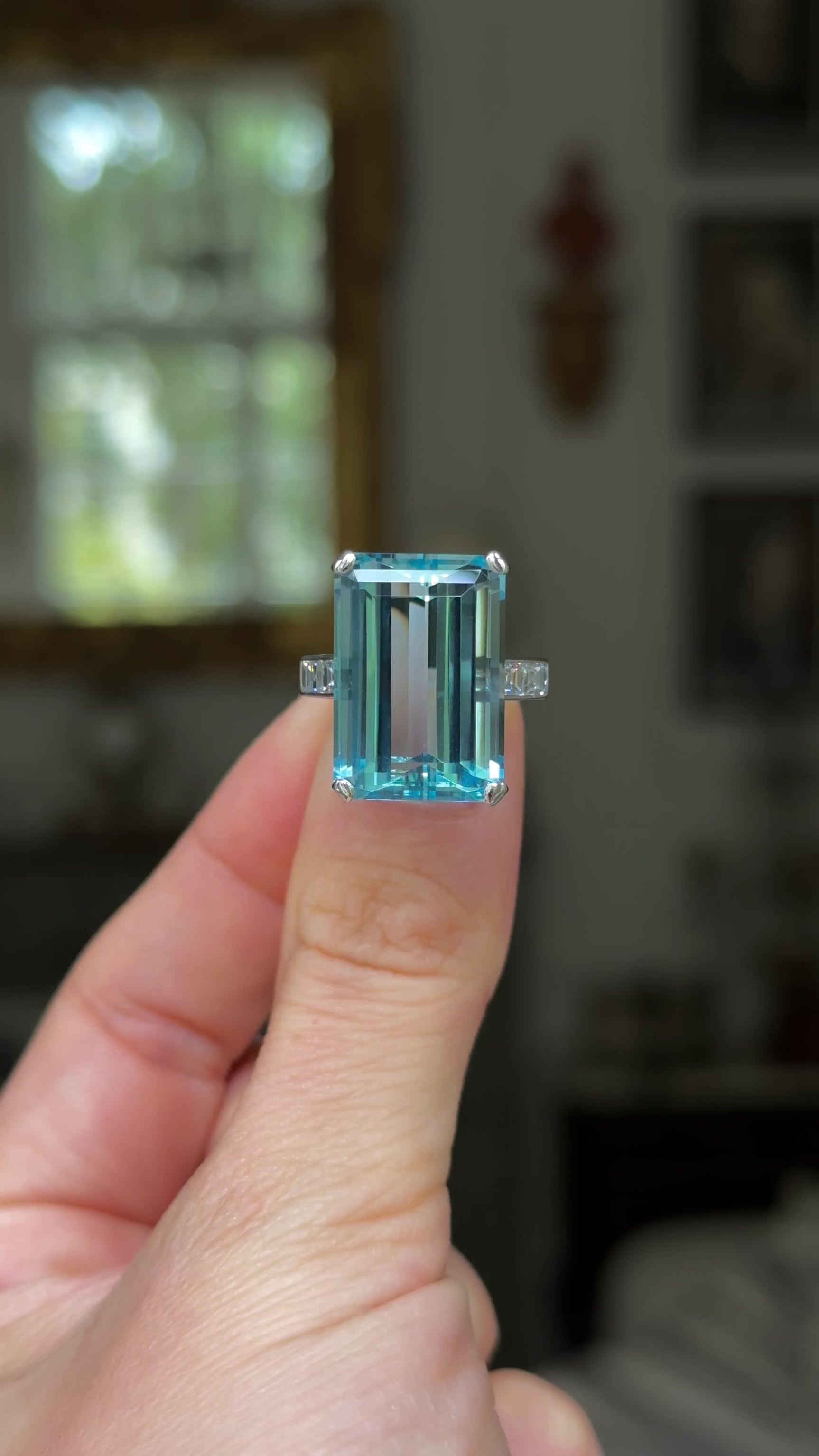 vintage aquamarine and diamond cocktail ring, held in fingers and moved around to give perspective.