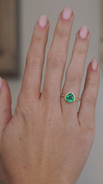 Video showcasing the emerald engagement ring on the hand as light moves across the pear-cut stone.