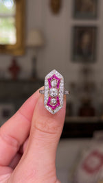 ,Antique ruby and diamond ring held in fingers and moved around.