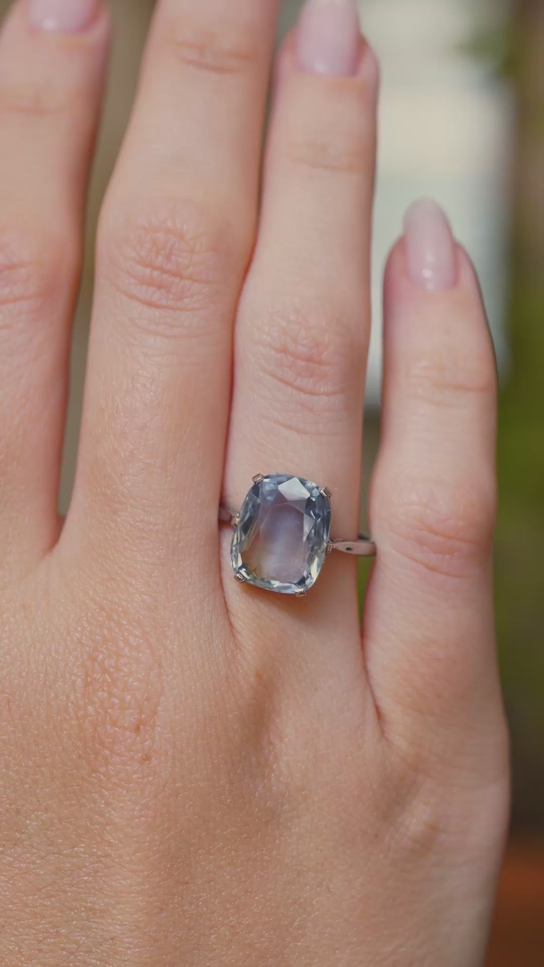 A video showing the sapphire ring being worn on the finger, the hand turns to show different angles of the ring being worn.