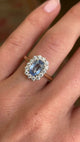 Video of an Antique-inspired, blue sapphire and diamond cluster engagement ring in gold worn on a hand.