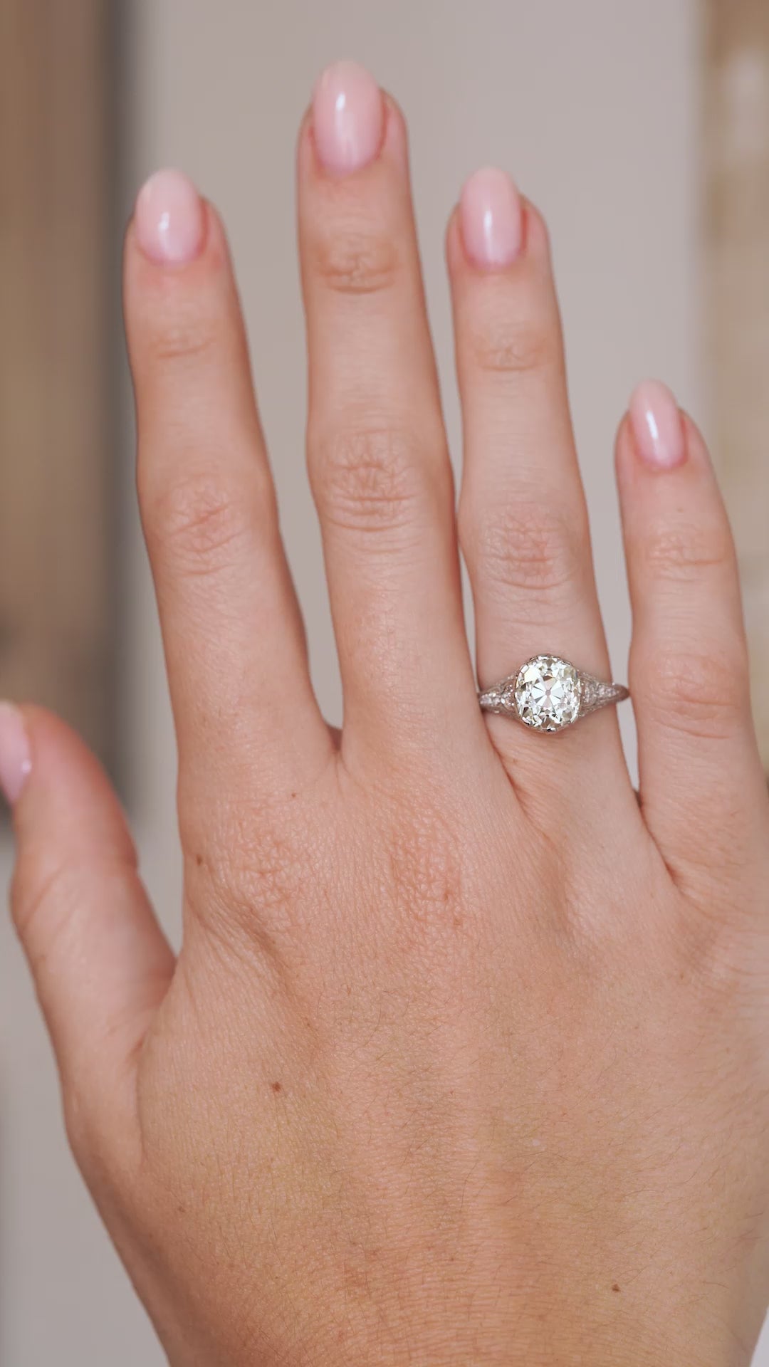 Video of the antique diamond engagement ring on the hand, capturing the character of its old-mine cut centre stone.