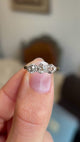Close-up video of an antique Edwardian yellow gold ring showcasing a trio of old-cut fancy coloured diamonds in brown, pink and champagne hues.