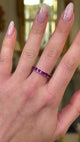 Vintage ruby eternity ring worn on hand and moved around to give perspective.