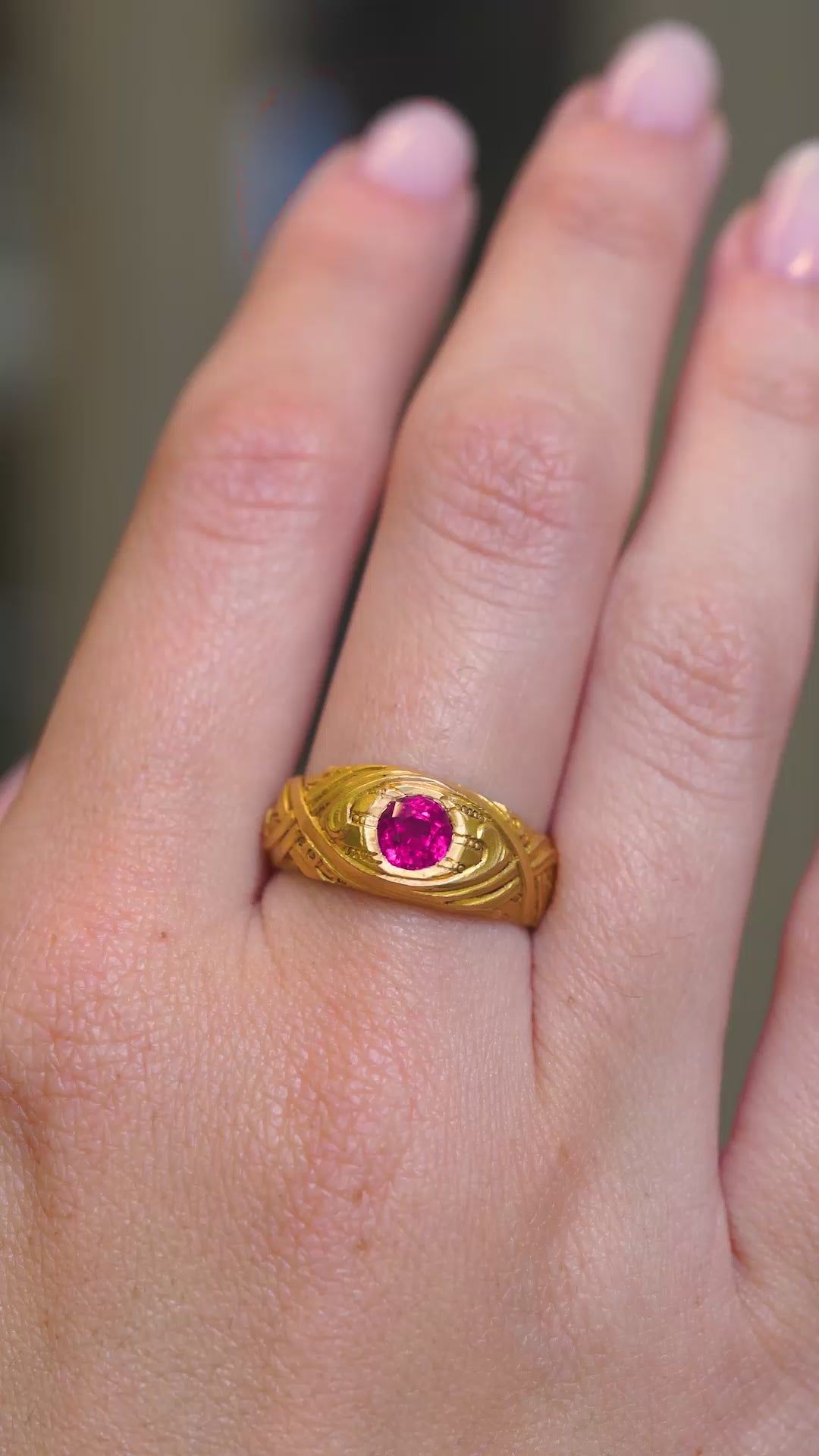 A video of a Art Nouveau antique natural ruby single-stone yellow gold ring worn on the hand and shown at a distance. 