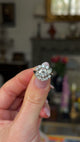 Cartier diamond engagement ring held in fingers and moved around to give perspective.