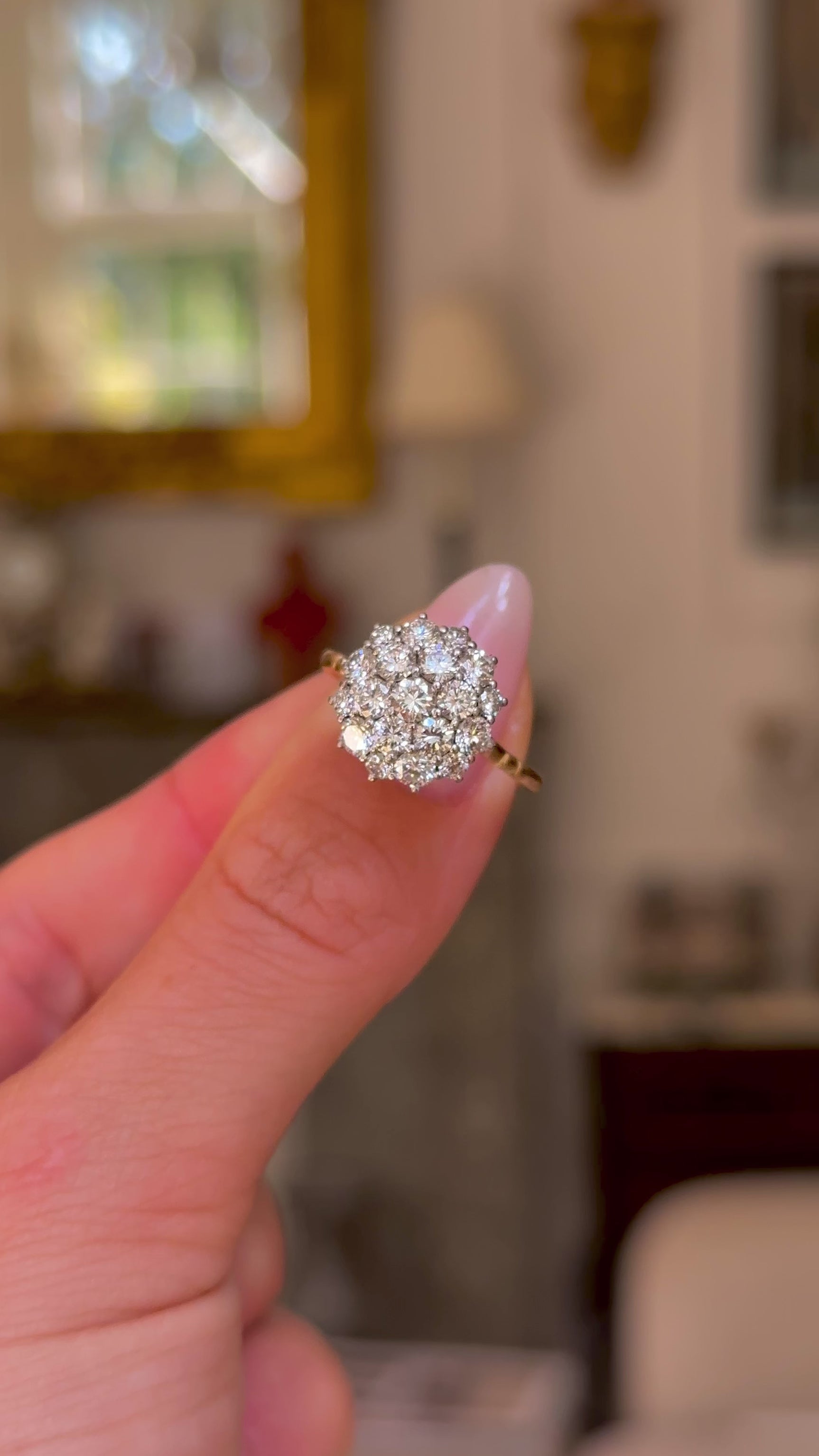 1980s diamond cluster engagement ring worn in fingers and moved around to give perspective.