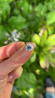 Vintage Sapphire and Diamond Cluster Ring, 18ct Yellow Gold held in fingers.