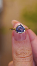 A video featuring a pear-cut blue sapphire, this antique-inspired yellow gold solitaire ring offers a timeless engagement ring design.