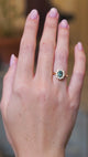 Green sapphire cluster ring worn on hand showing rich green tone and natural movement.