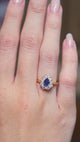 a video of a Vintage sapphire and diamond cluster engagement ring worn on the hand