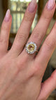 yellow sapphire and diamond cluster ring worn on hand and moved around to give perspective.