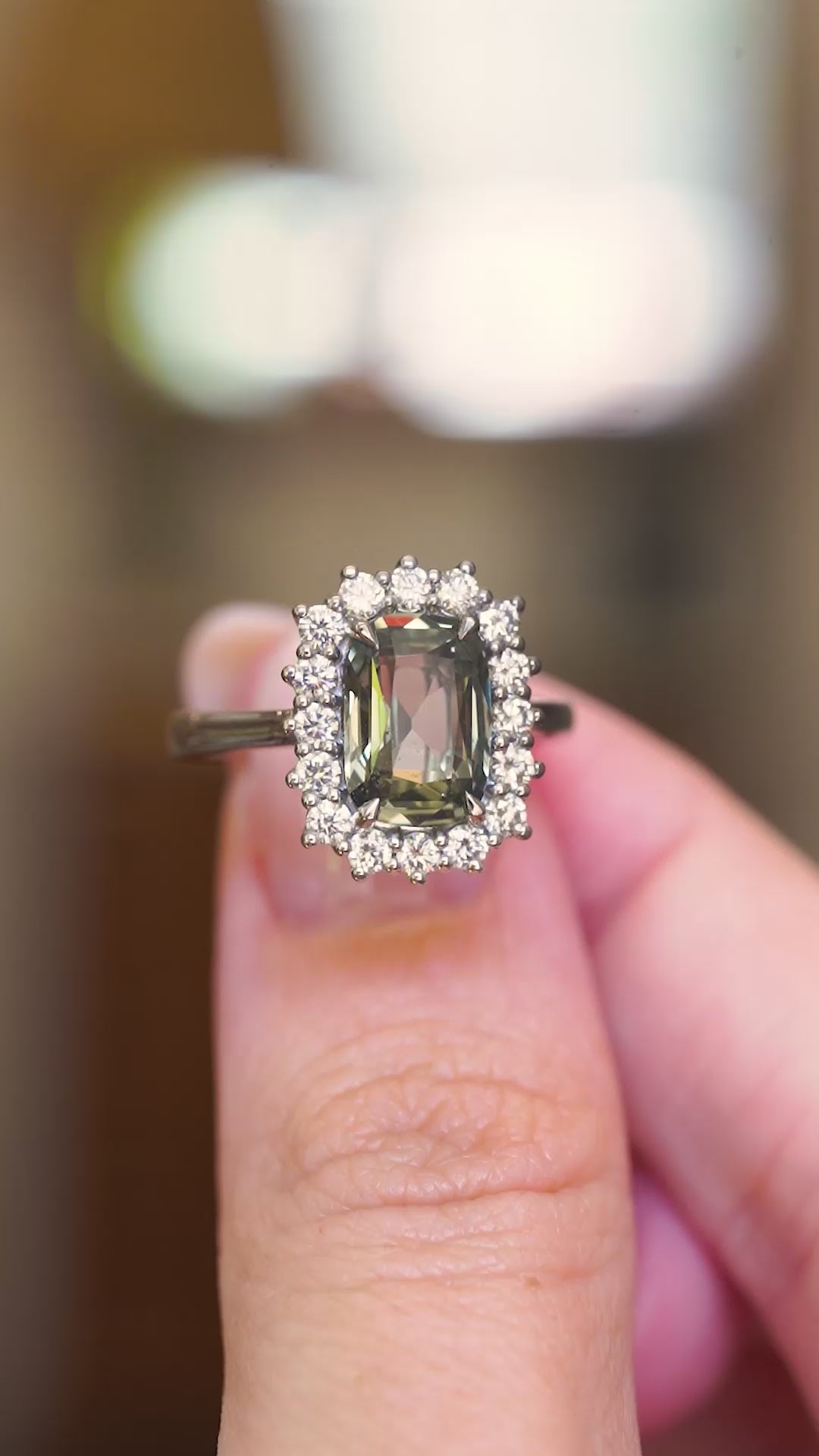 Antique-inspired, green cushion-cut sapphire and diamond cluster engagement ring