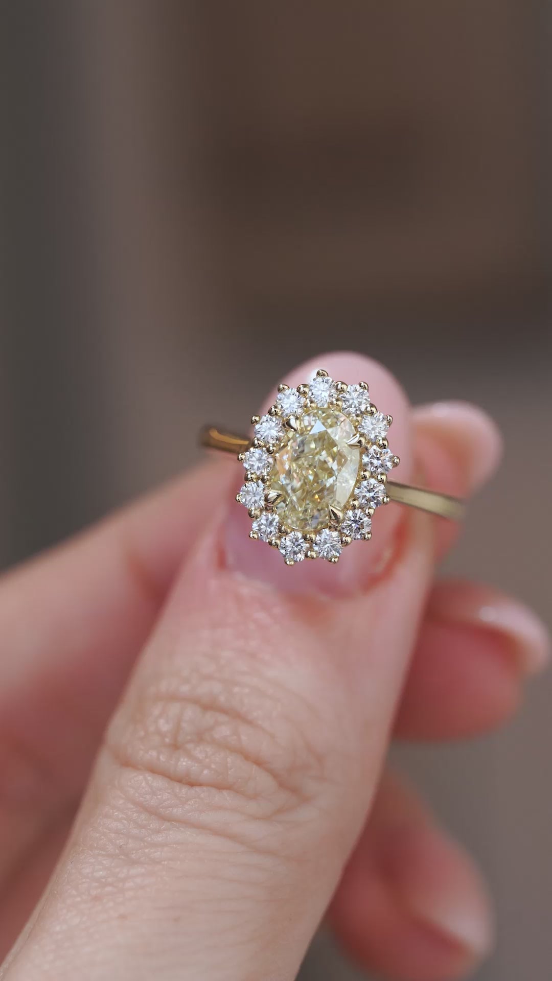 Video: Close-up of the antique-inspired diamond cluster ring held between fingers, showcasing its sparkle and intricate design.