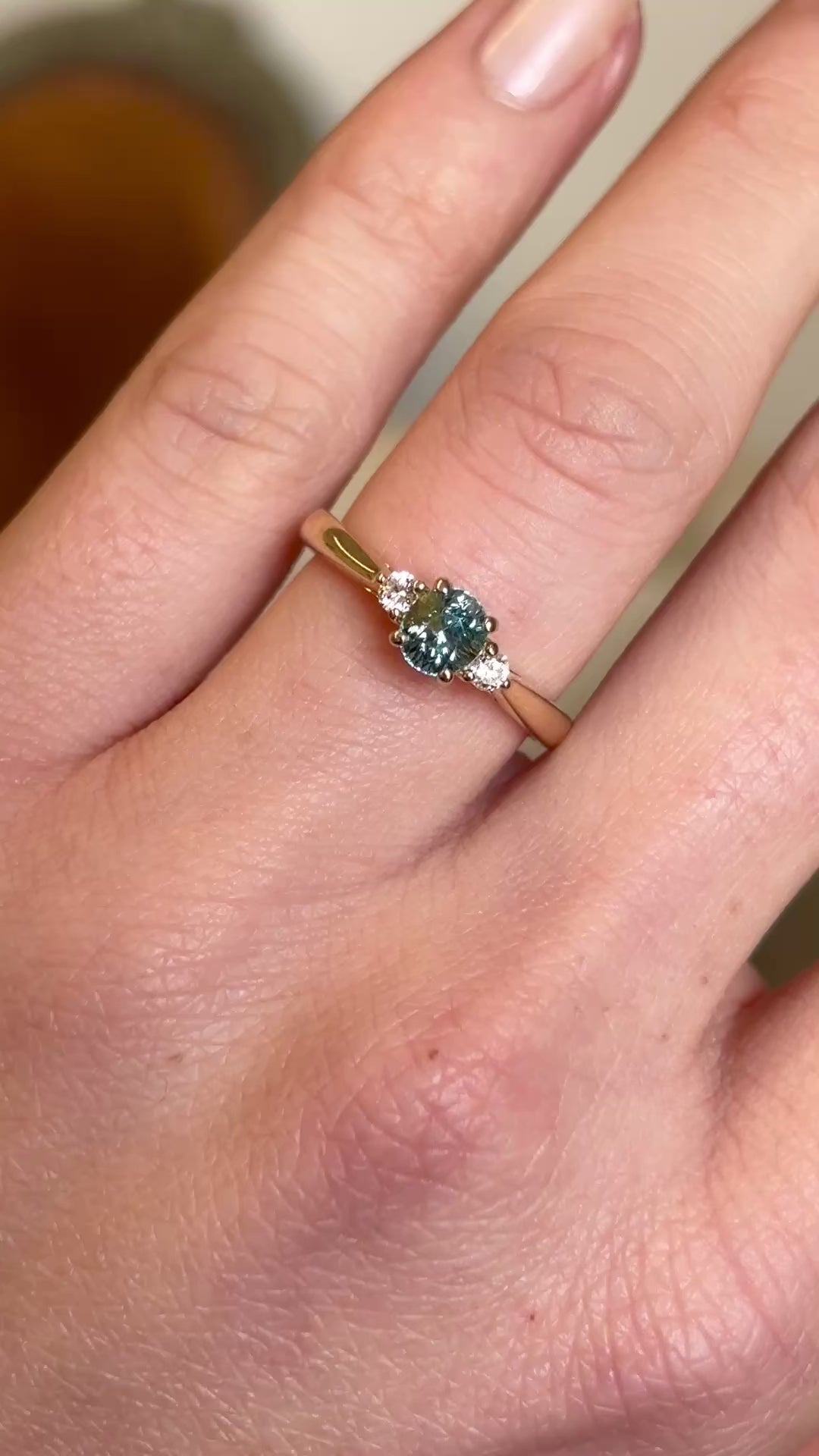 Teal sapphire and diamond three-stone engagement ring
