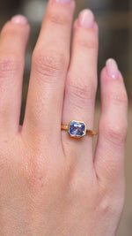 A video of an antique-inspired blue sapphire solitaire engagement ring in yellow gold worn on a hand.