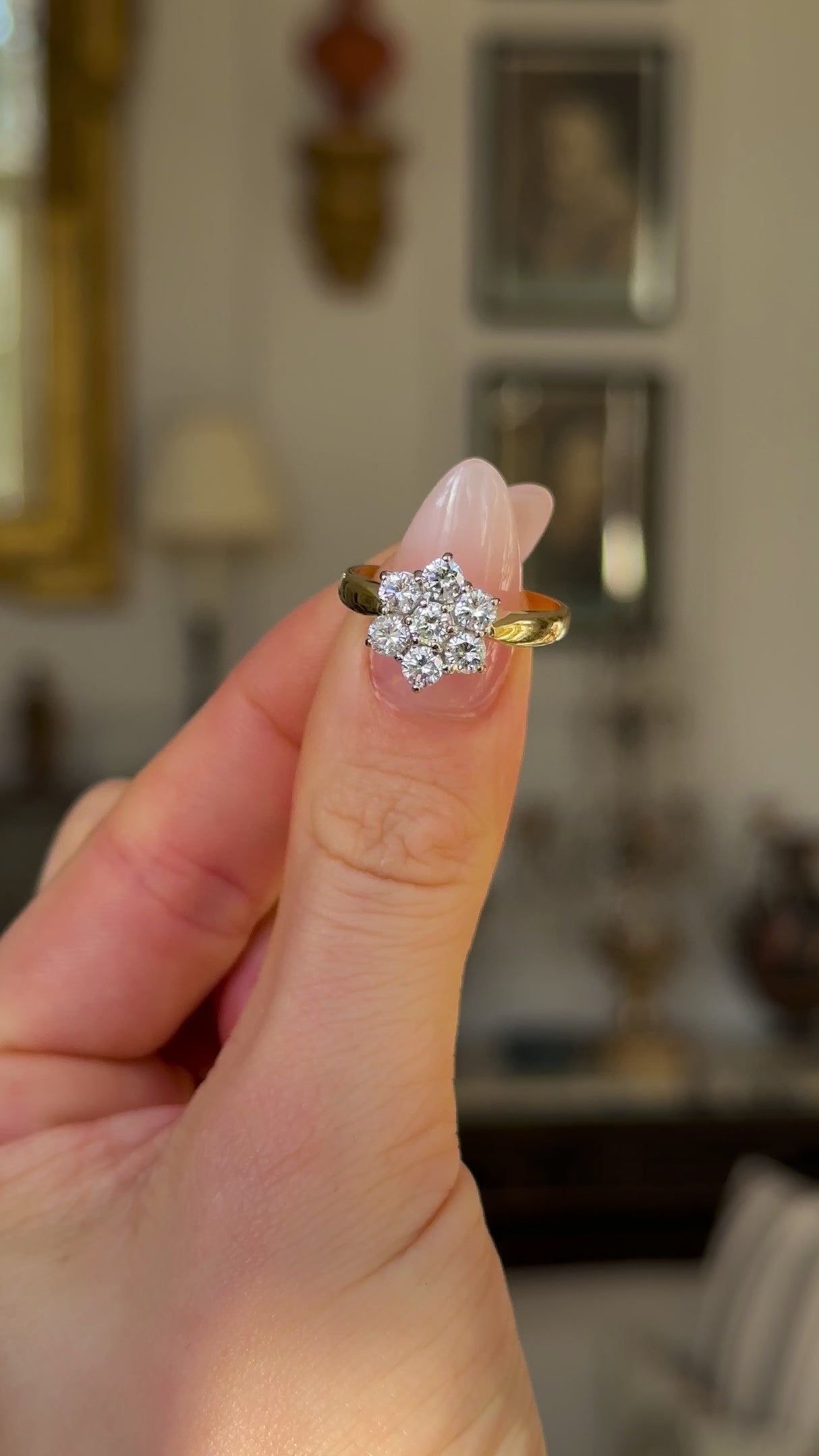 Vintage, 1990s Diamond Cluster Engagement Ring, 18ct Yellow and White Gold held in fingers and rotated to give perspective.