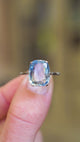 Blue sapphire ring showing light reflections and simple antique setting.