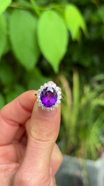 Vintage, 1980s Amethyst and Diamond Cluster Cocktail Ring, 18ct Yellow Gold and Platinum held in fingers.