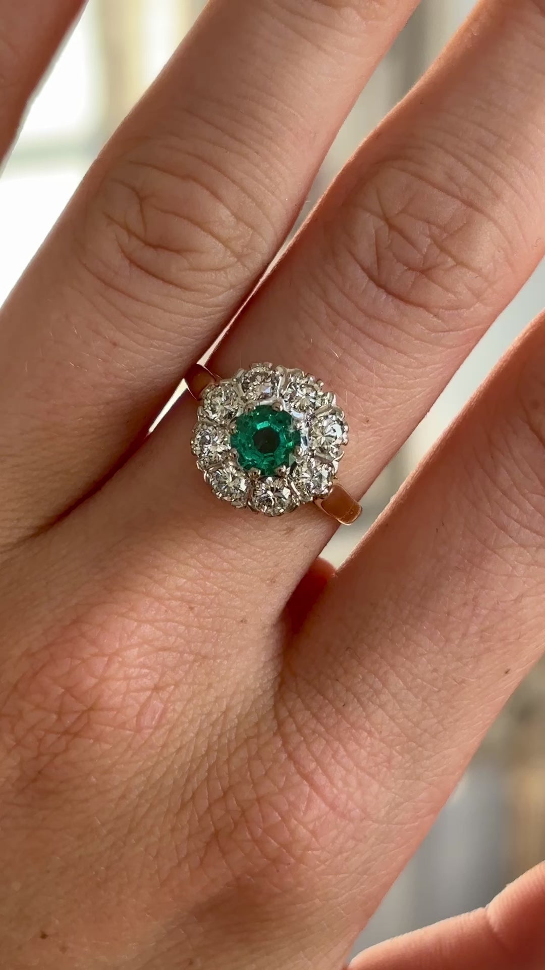 Vintage, 1980s emerald & diamond cluster ring worn on hand.