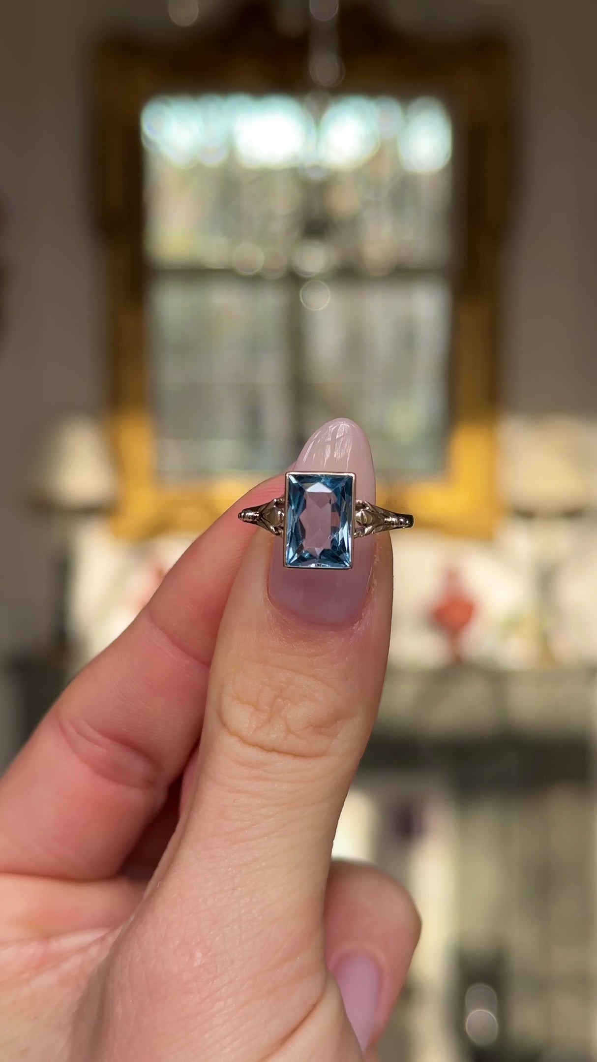 antique aquamarine single stone ring held in fingers and moved around to give perspective.