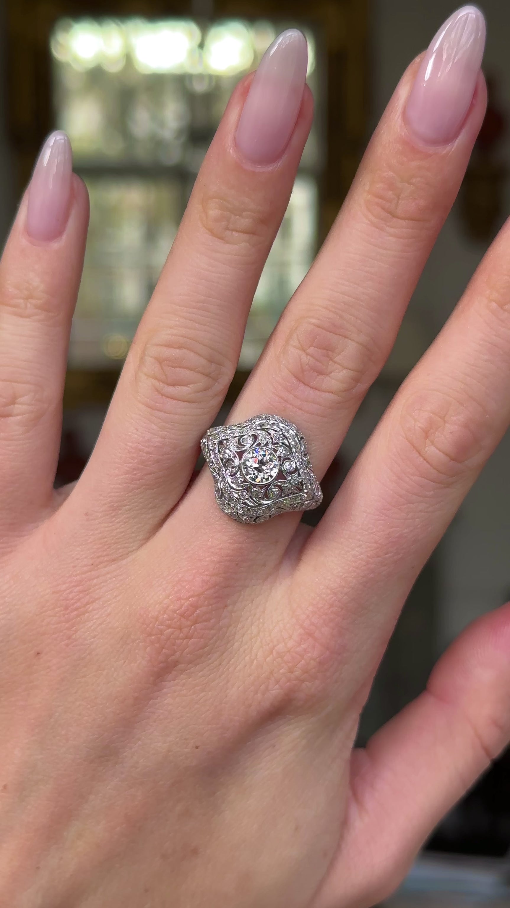 edwardian diamond bombe ring worn on hand and moved around to give perspective.