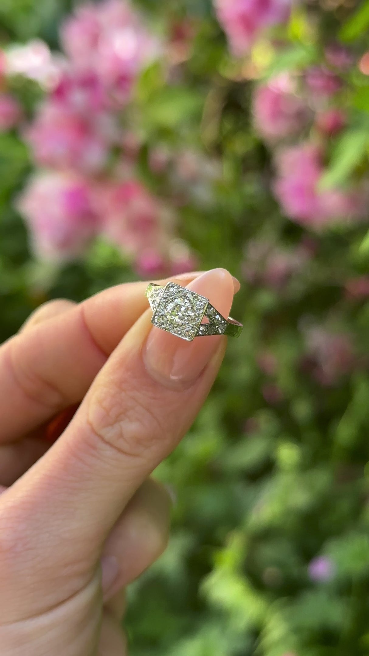 Vintage, 1940s Diamond Engagement Ring 18ct White Gold and Platinum held in fingers.