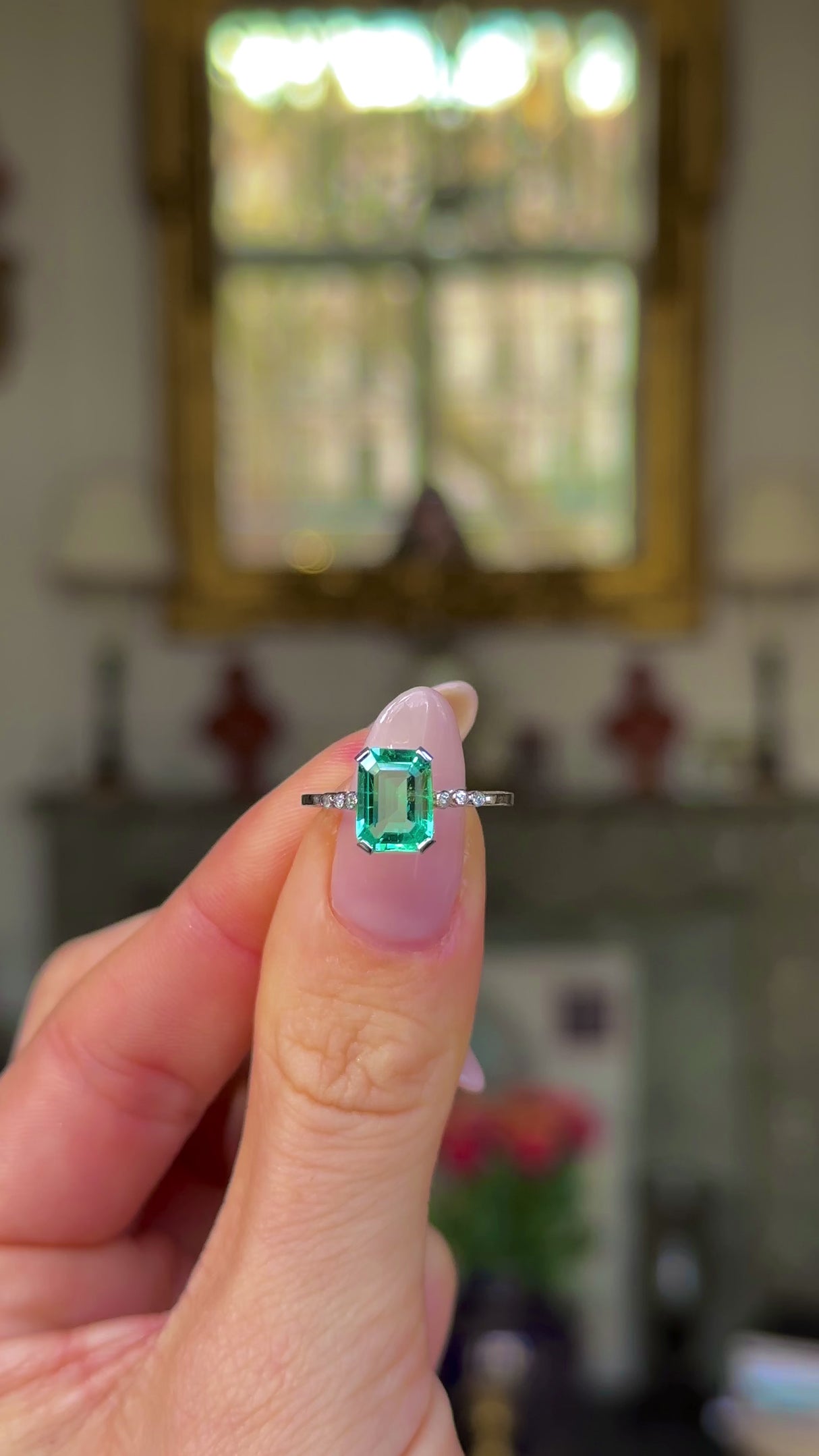Edwardian single stone ring held in fingers and moved around to give perspective.