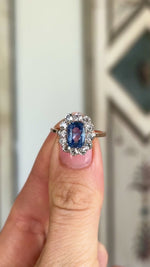 Antique, Edwardian blue & white sapphire cluster ring worn on hand.