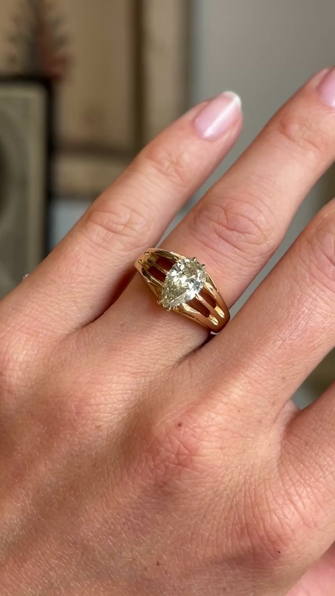 Video of an Antique, Edwardian yellow pear-cut diamond solitaire gypsy ring in yellow gold on a finger on hand