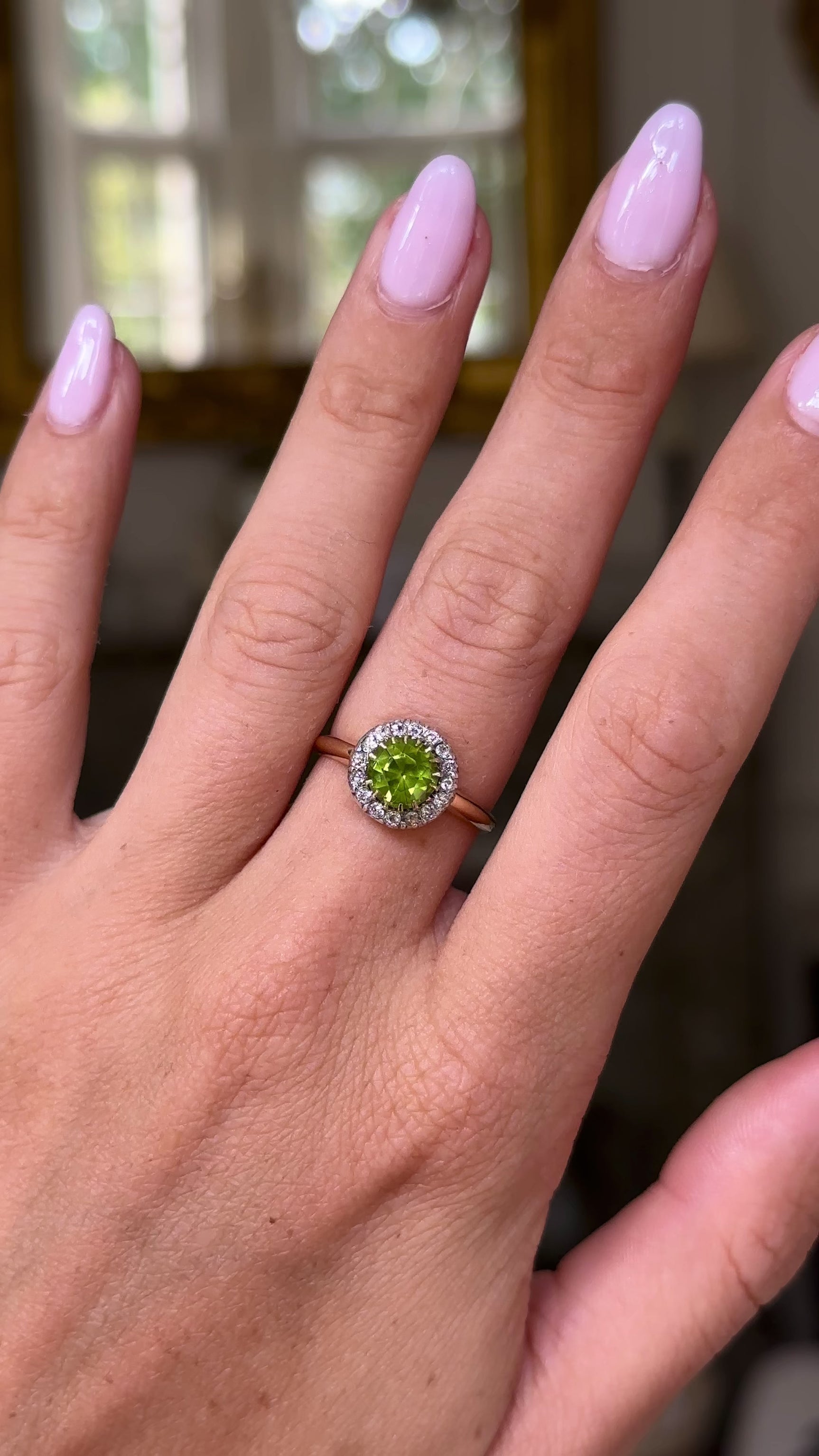 Edwardian peridot and diamond cluster ring, worn on hand and moved around to give perspective.