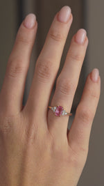 Video showcasing the pink sapphire and diamond trefoil ring on the hand as the gemstones catch the light.