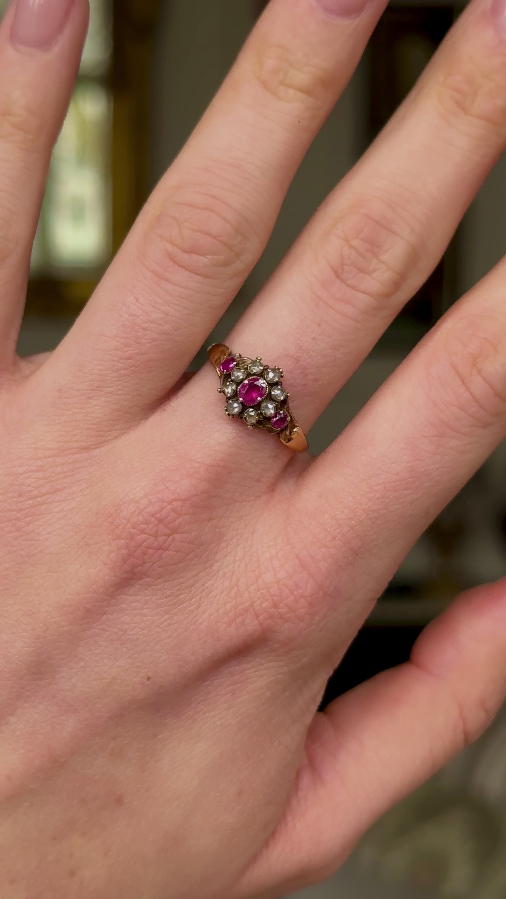Antique, Edwardian Ruby and Diamond Cluster Ring, worn on hand and rotated to give perspective.
