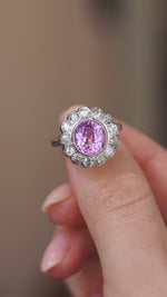 Video close-up of the 1960s sapphire ring balanced on a fingertip, highlighting its floral cluster design.