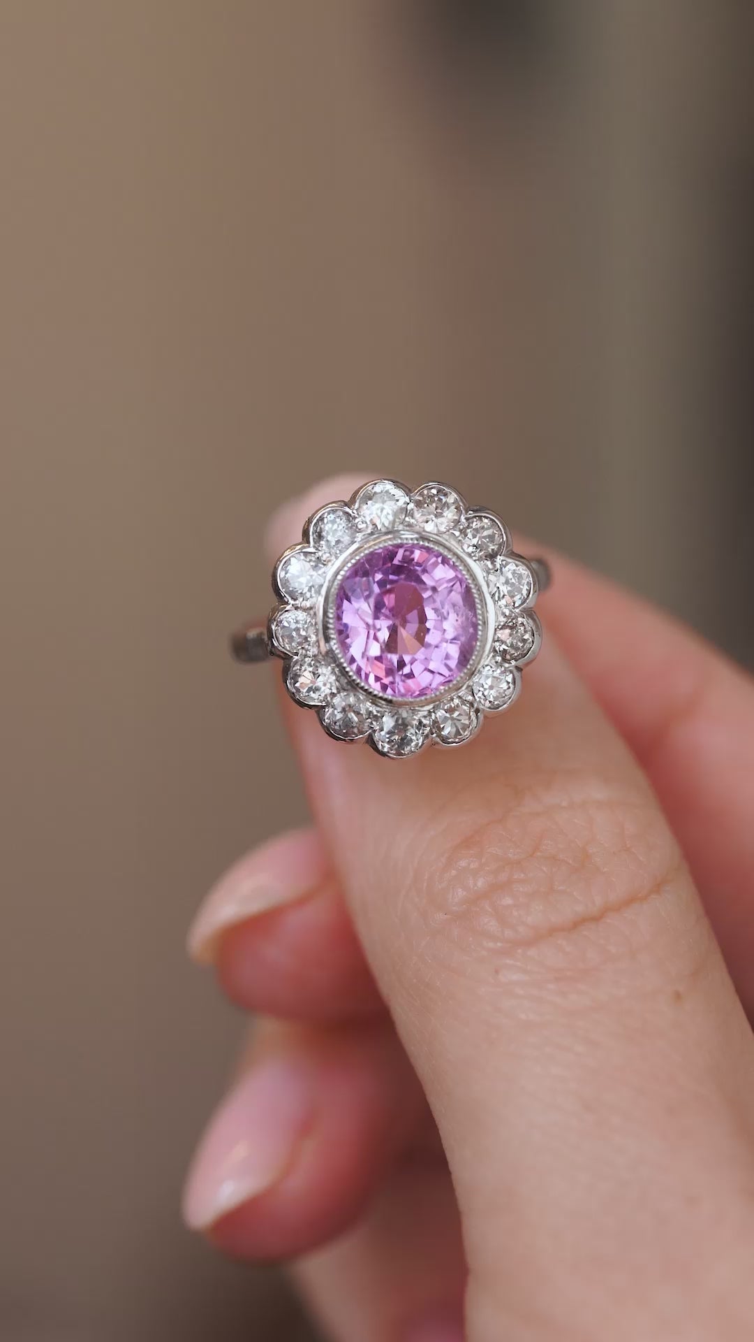 Video close-up of the 1960s sapphire ring balanced on a fingertip, highlighting its floral cluster design.