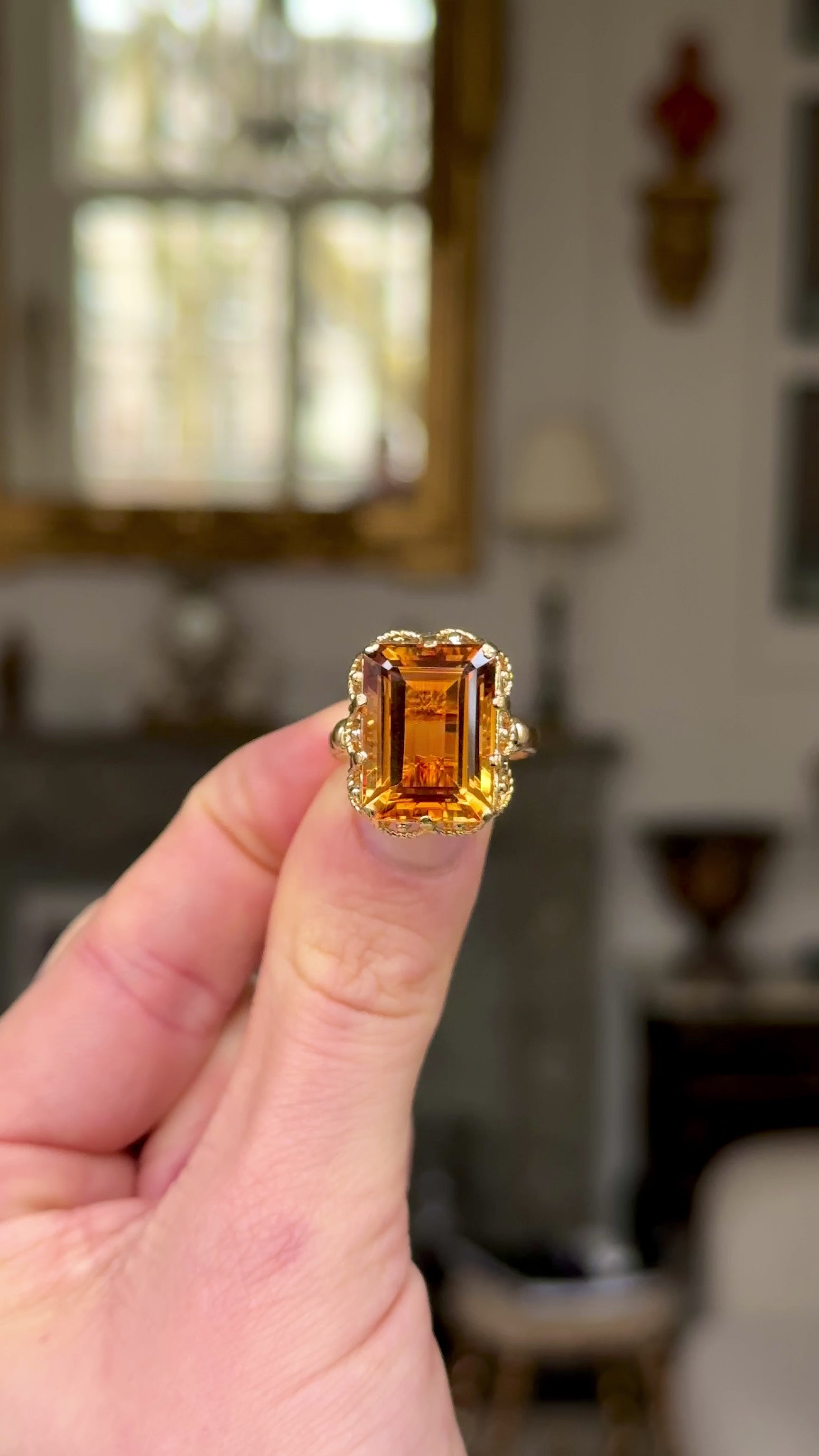 Antique, 1880s Citrine Ring with Rope Metal Work, held in fingers and moved around to give perspective.