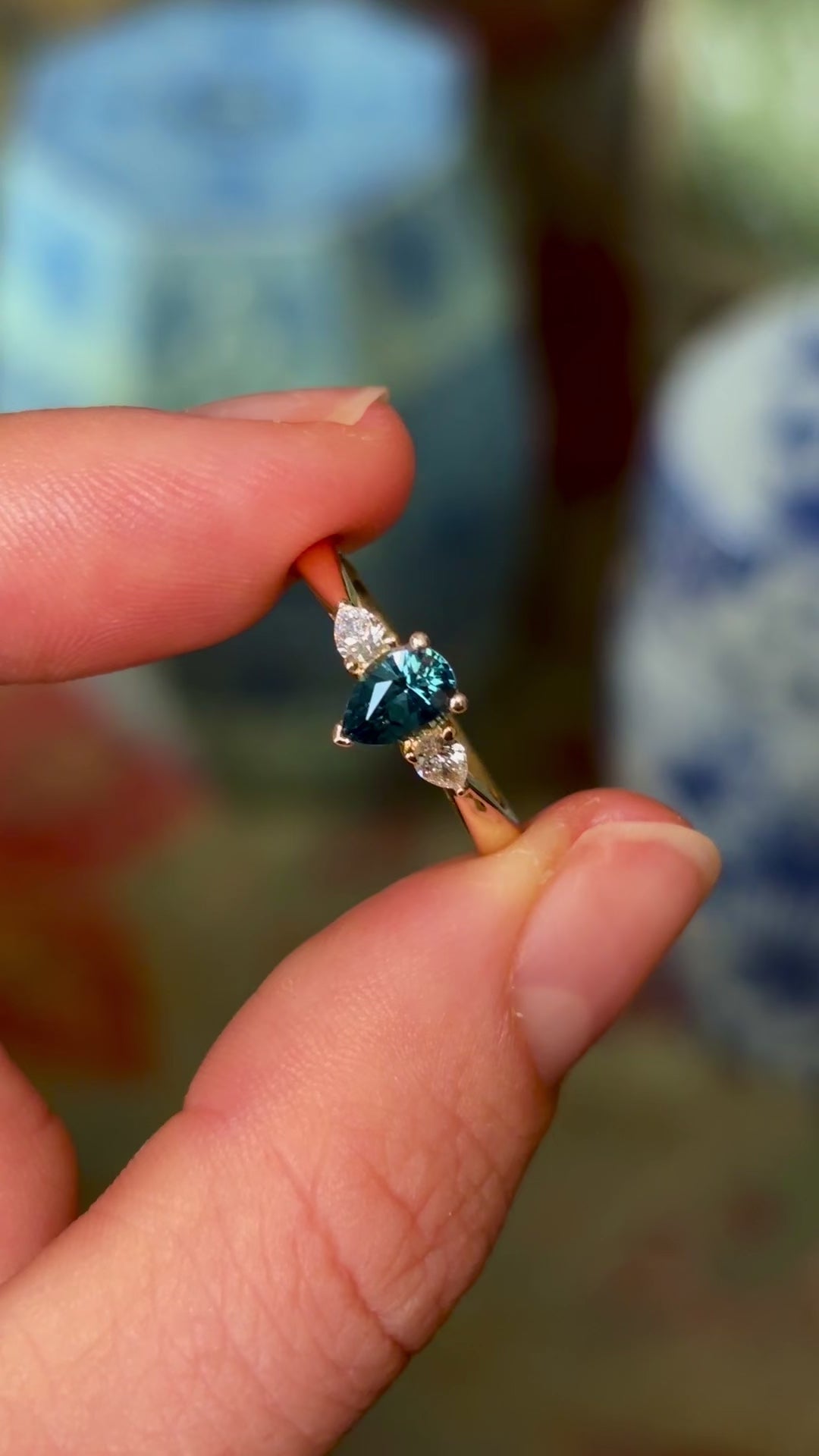 Pear-cut teal sapphire & diamond three-stone ring