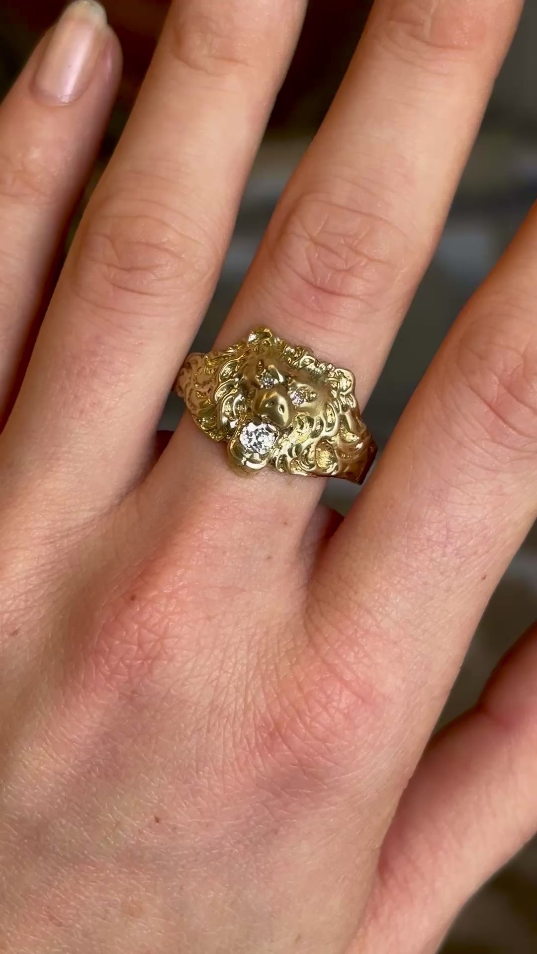 Vintage 1950s old-cut diamond lion’s head ring with diamond-set eyes worn on hand and moved backwards. 