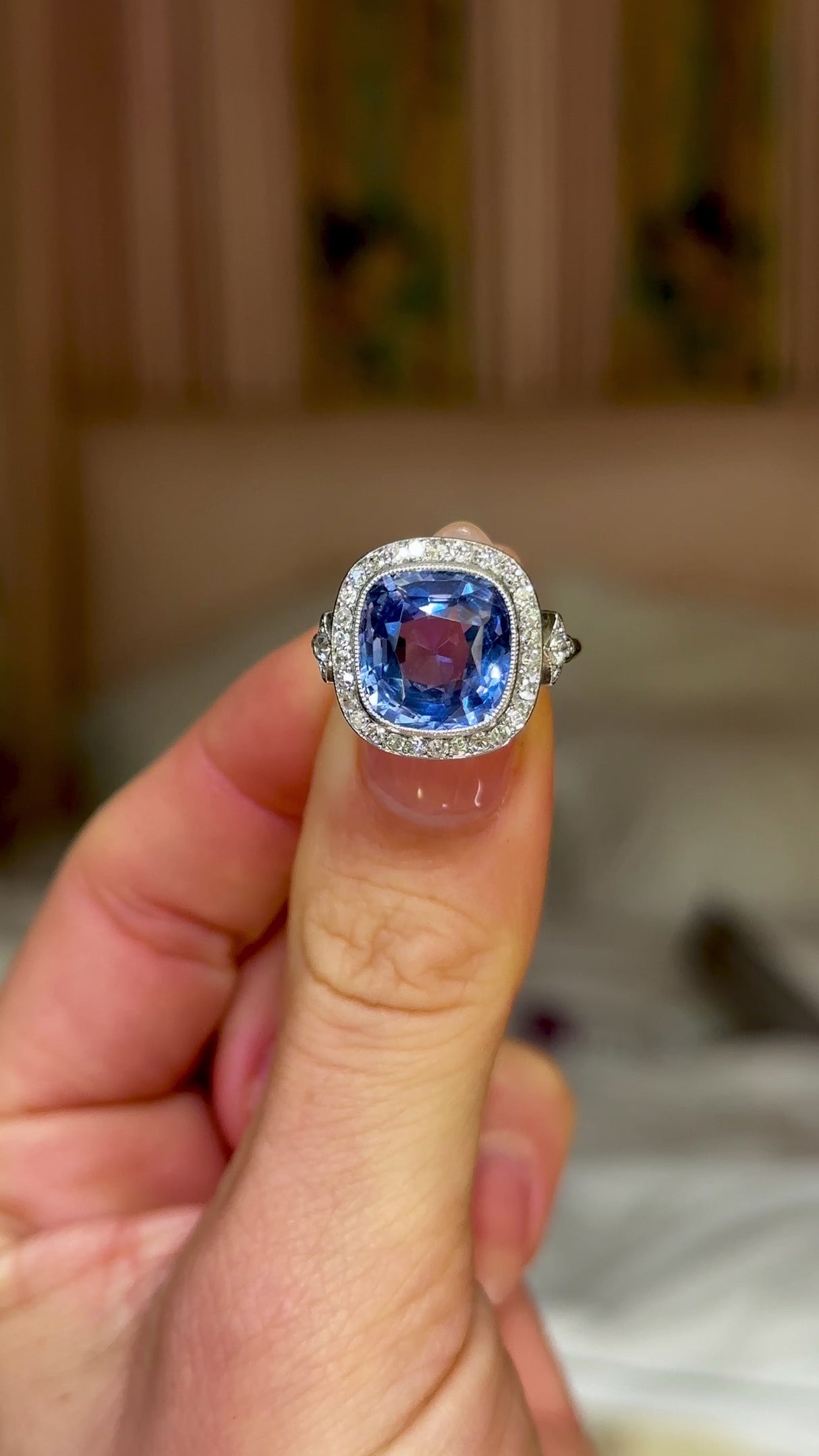 Antique, Belle Époque Sapphire and Diamond Cluster Ring, 18ct White Gold held in fingers and rotated to give perspective.