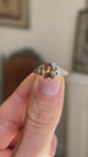 Antique-inspired hazelnut-brown diamond and rose-cut diamond engagement ring showcasing a hazelnut-brown diamond centre stone and rose-cut diamond detailing, held by hand to highlight the setting and craftsmanship.