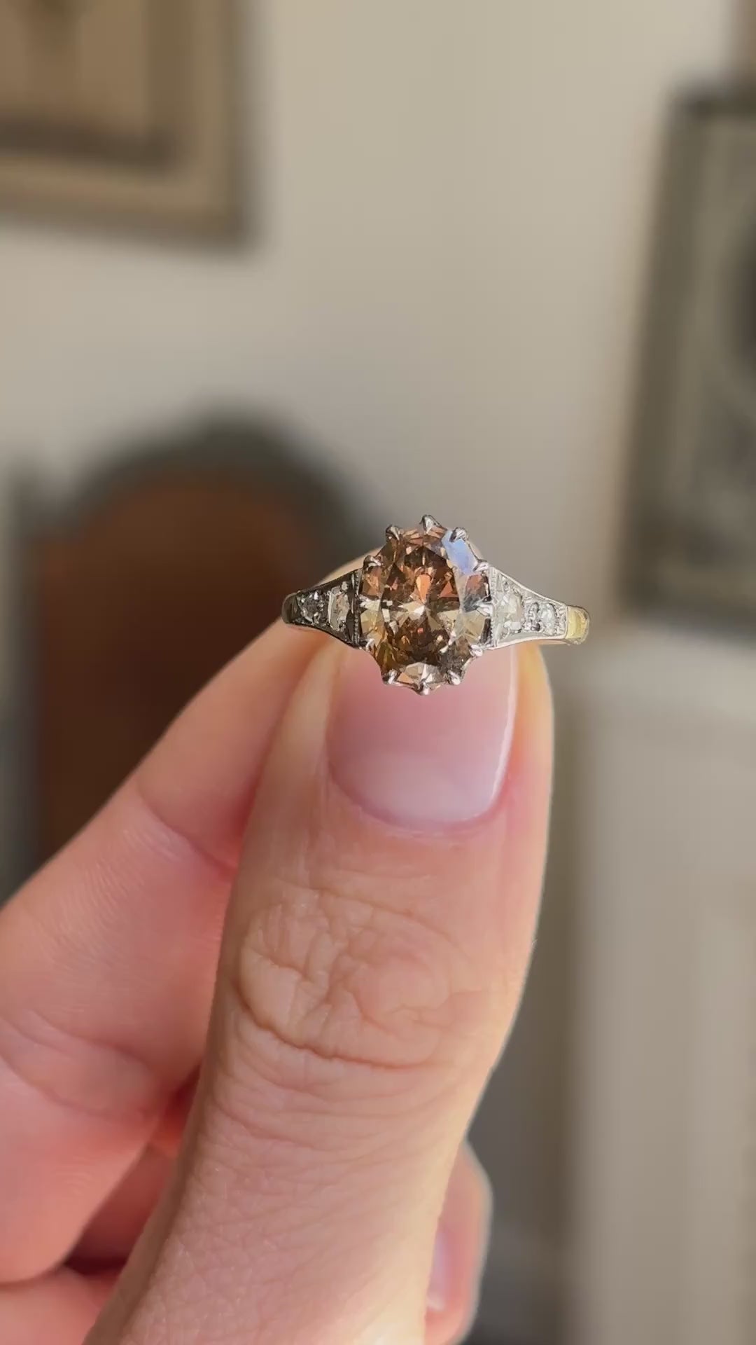 Antique-inspired hazelnut-brown diamond and rose-cut diamond engagement ring showcasing a hazelnut-brown diamond centre stone and rose-cut diamond detailing, held by hand to highlight the setting and craftsmanship.